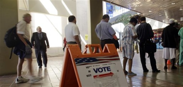 In this Oct. 18, 2010, photo, voters stand in line on the first day of early voting in Miami. Election Day already is over for more than 3 million Americans, and a surprising number of them are Democrats. Perhaps 30 percent or more of all votes are likely to be cast early. (AP Photo/Alan Diaz)